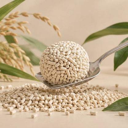A very firm clump of light cream tofu and cassava litter pellets on a spoon above loose pellets
